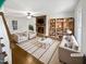 Bright living room featuring a fireplace, bookshelves, and stylish furnishings on a hardwood floor at 5356 Baywood Forest Dr, Knightdale, NC 27545