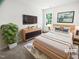 A serene main bedroom featuring soft lighting, a large window, and simple, elegant decor at 5356 Baywood Forest Dr, Knightdale, NC 27545