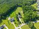 Aerial view of a home with a large, fenced pasture, pool, and lush greenery at 545 Olivia Way, Selma, NC 27576