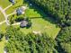 Aerial view highlighting a home with a swimming pool, lush greenery, and fenced pasture at 545 Olivia Way, Selma, NC 27576