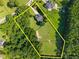 Aerial view of a property line showcasing a home and expansive pasture area at 545 Olivia Way, Selma, NC 27576