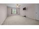 Spacious carpeted bedroom with a ceiling fan, large window, and mounted television at 545 Olivia Way, Selma, NC 27576