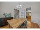 Open dining room with hardwood flooring and stylish furniture adjacent to the kitchen at 545 Olivia Way, Selma, NC 27576