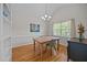 Cozy dining room with hardwood floors, a rustic wood table, and a decorative light fixture at 545 Olivia Way, Selma, NC 27576