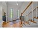 Welcoming foyer with hardwood floors, staircase with white railing, and ample natural light at 545 Olivia Way, Selma, NC 27576