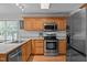 Well-equipped kitchen featuring stainless steel appliances and abundant wood cabinetry at 545 Olivia Way, Selma, NC 27576