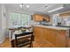Spacious eat-in kitchen with wood cabinets, stainless appliances, large windows and natural lighting at 545 Olivia Way, Selma, NC 27576