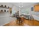 Bright eat-in kitchen has bar seating and is open to a beautiful living room with wood wall at 545 Olivia Way, Selma, NC 27576