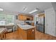 Spacious kitchen featuring wood cabinets, stainless steel appliances, and a center island at 545 Olivia Way, Selma, NC 27576