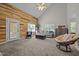 Open concept living room boasts vaulted ceiling and wood accent wall with access to the exterior at 545 Olivia Way, Selma, NC 27576