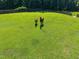 Aerial view of the horse pasture with green grass and two horses surrounded by a wooden fence at 545 Olivia Way, Selma, NC 27576