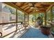 Cozy screened porch features a hanging chair and backyard views at 545 Olivia Way, Selma, NC 27576