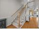 Carpeted staircase featuring wood railing and white spindles leading to an upper level at 545 Olivia Way, Selma, NC 27576