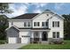 Charming two-story home featuring stone accents, a covered porch, and a well-manicured lawn at 56 Alex Farm Ct # 24, Zebulon, NC 27597