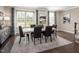Elegant dining room featuring a large window, stylish furnishings, and a modern chandelier at 601 Rockwater Path, Durham, NC 27713