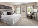 Inviting primary bedroom with ample natural light, neutral decor, and a cozy sitting area at 601 Rockwater Path, Durham, NC 27713