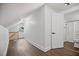 Bright attic space with wood-look flooring and access to a bathroom at 606 E Club Blvd, Durham, NC 27704