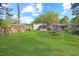 Well-maintained backyard featuring lush green grass and surrounding trees at 606 E Club Blvd, Durham, NC 27704