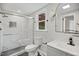 Modern bathroom featuring marble-tiled shower, sleek vanity, and stylish lighting for a luxurious feel at 606 E Club Blvd, Durham, NC 27704