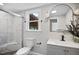 Updated bathroom features a sleek vanity, marble tiled shower, and a window at 606 E Club Blvd, Durham, NC 27704