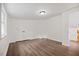 Bedroom with laminate floors, double closet, and flush mount light fixture at 606 E Club Blvd, Durham, NC 27704
