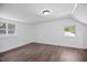 Newly renovated bedroom features wood-look floors and two windows for lots of light at 606 E Club Blvd, Durham, NC 27704