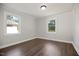 This bedroom is freshly painted and offers laminate floors and two windows at 606 E Club Blvd, Durham, NC 27704