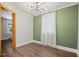 Bright dining room with hardwood floors, modern chandelier and large windows, ready for entertaining at 606 E Club Blvd, Durham, NC 27704