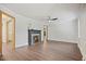 Open living room featuring a fireplace, fan, and hardwood floors at 606 E Club Blvd, Durham, NC 27704