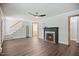 Open-concept living room with hardwood floors, fireplace, staircase, and doorway views at 606 E Club Blvd, Durham, NC 27704