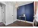 This home office features blue accent wall, modern gold desk and stylish light fixture at 606 E Club Blvd, Durham, NC 27704