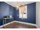 This blue-walled office offers a modern light and gold desk at 606 E Club Blvd, Durham, NC 27704