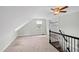 Finished attic room with carpeted floors, sloped ceilings and black metal railing at 625 New Road Rd, Raleigh, NC 27608