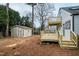 View of the backyard featuring a two-story deck and storage shed at 625 New Road Rd, Raleigh, NC 27608
