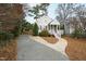 Beautifully landscaped front yard with a charming home, driveway, and inviting walkway at 625 New Road Rd, Raleigh, NC 27608