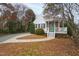 A cozy cottage with a welcoming front porch and a walkway leading to the entrance at 625 New Road Rd, Raleigh, NC 27608