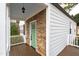 Charming porch with stone accents, white railings, and a quaint, light-green front door at 625 New Road Rd, Raleigh, NC 27608