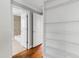 Hallway with hardwood flooring, neutral paint and a view to the bathroom at 625 New Road Rd, Raleigh, NC 27608