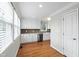Well-lit kitchen boasting white cabinets, stainless steel appliances, and a brick backsplash at 625 New Road Rd, Raleigh, NC 27608