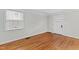 Bright, airy living room with hardwood floors, freshly painted walls, and a large window at 625 New Road Rd, Raleigh, NC 27608