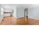 Open living space with hardwood floors, white trim, connecting the kitchen with the living room at 625 New Road Rd, Raleigh, NC 27608