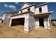 Under-construction home showing multiple units with a two-car garage, illustrating the building process and future potential at 69 Willow Cameron Way, Angier, NC 27501
