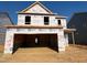 Under-construction home showing frame with a two-car garage, illustrating the building process and future potential at 69 Willow Cameron Way, Angier, NC 27501