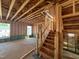 Exposed home framework showcasing stairwell access to upper level with an open space to be customized at 69 Willow Cameron Way, Angier, NC 27501