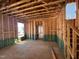 Spacious, exposed home framework showcasing customizable open space with a stairwell access to upper level at 69 Willow Cameron Way, Angier, NC 27501
