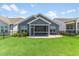 Picture of a grassy backyard featuring a gray home with white trim and a screened porch at 705 Churton Pl, Cary, NC 27518