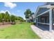 Backyard view of a gray home with professionally landscaped yard, stone patio, and screened porch at 705 Churton Pl, Cary, NC 27518