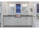 This bathroom has double sinks, quartz countertops, tile floors, and modern fixtures at 705 Churton Pl, Cary, NC 27518