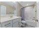Well-lit bathroom featuring a white vanity, framed mirror, and a shower-tub combination with a curtain at 705 Churton Pl, Cary, NC 27518