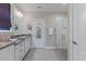 This bathroom has double sinks, quartz countertops, tile floors, a shower, and closet access at 705 Churton Pl, Cary, NC 27518